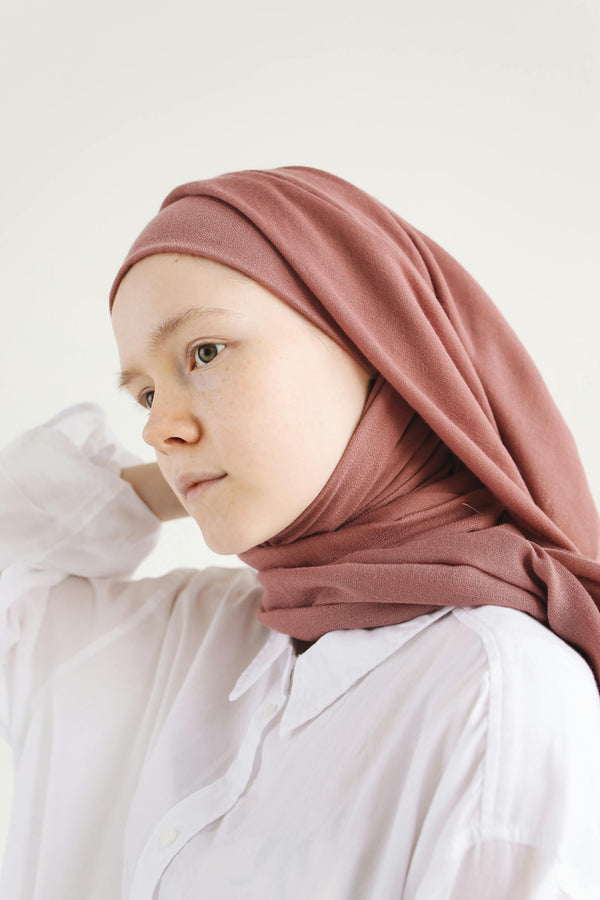 Woman wearing dusty rose chiffon hijab with soft natural lighting